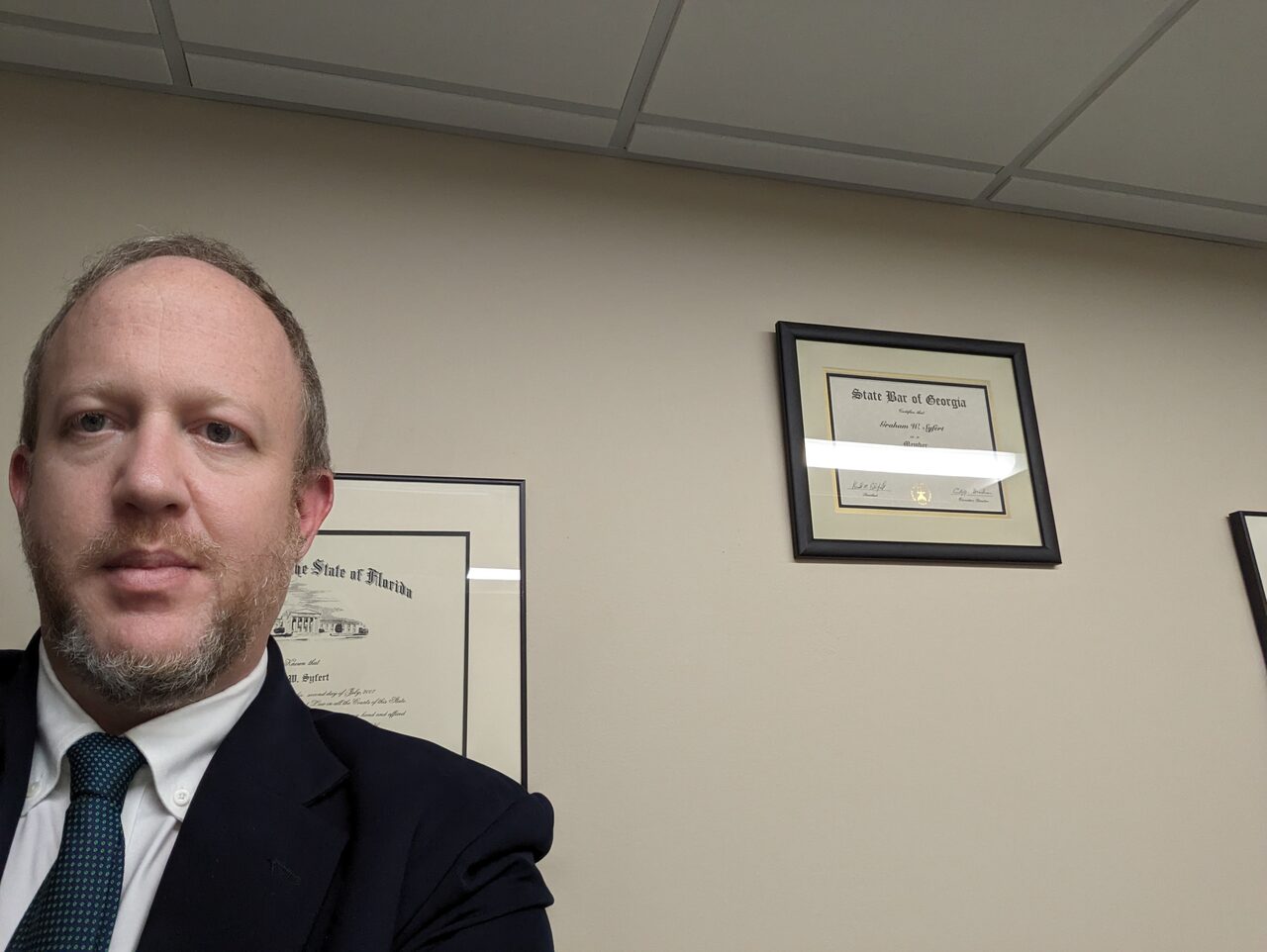 Graham W. Syfert with his Florida and Georgia bar admission certificates framed behind him